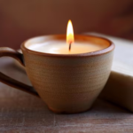 burning-candle-ceramic-cup-old-book_117466-43610-cropped